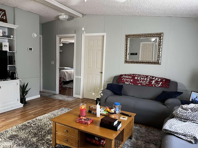 living room featuring lofted ceiling, dark hardwood / wood-style floors, and a textured ceiling