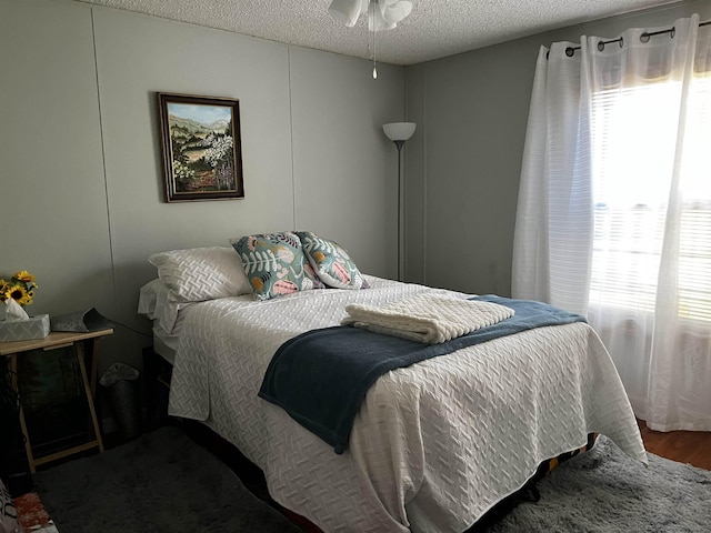 bedroom with wood-type flooring and a textured ceiling