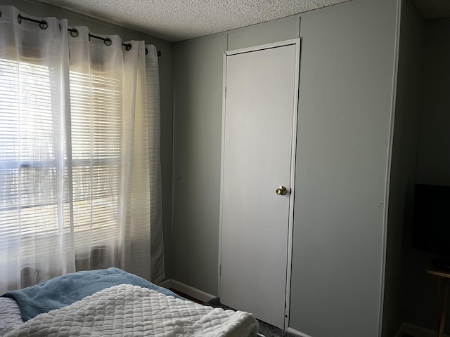 bedroom featuring a closet and a textured ceiling