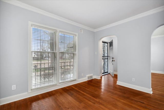 spare room with hardwood / wood-style flooring and crown molding