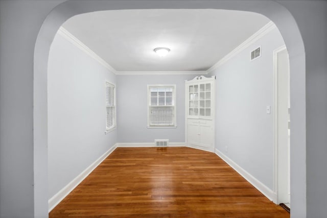 unfurnished room featuring crown molding and hardwood / wood-style flooring