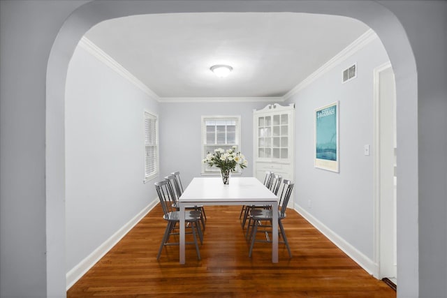 dining space featuring crown molding and hardwood / wood-style floors