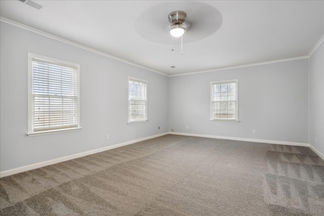 empty room with carpet, plenty of natural light, and crown molding