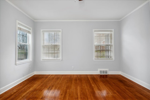 unfurnished room with hardwood / wood-style floors and ornamental molding