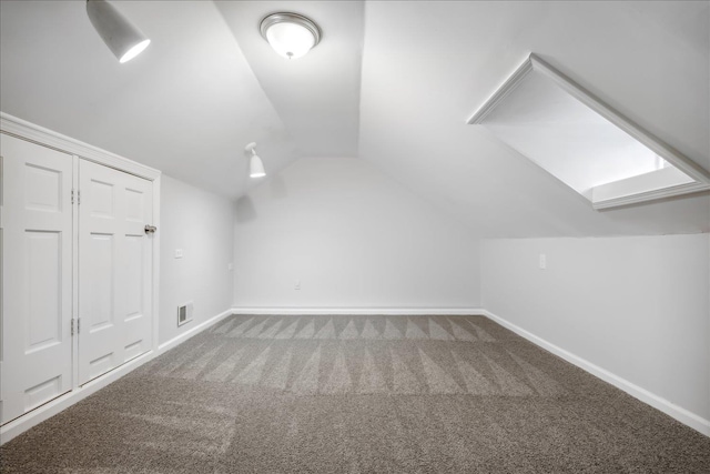 additional living space featuring carpet flooring and lofted ceiling