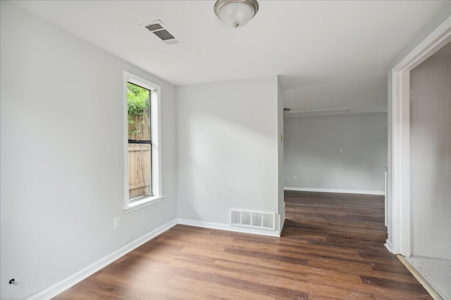 empty room with dark wood-type flooring