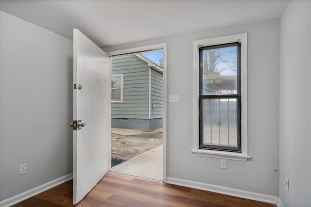 doorway to outside with wood-type flooring