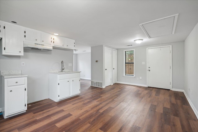 kitchen with sink, white cabinetry, and dark wood-type flooring