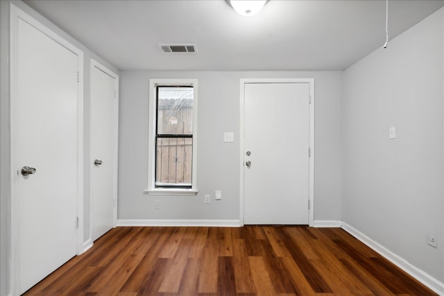 entryway with dark hardwood / wood-style floors