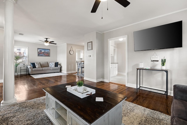 living room featuring ornate columns, ceiling fan, dark hardwood / wood-style floors, and ornamental molding