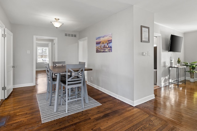 dining space with dark hardwood / wood-style floors