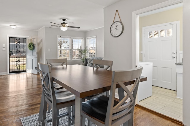 dining area featuring ceiling fan, ornamental molding, and light hardwood / wood-style flooring