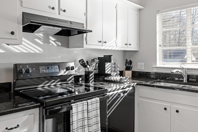 kitchen featuring dishwasher, sink, dark stone counters, stainless steel range with electric stovetop, and white cabinets