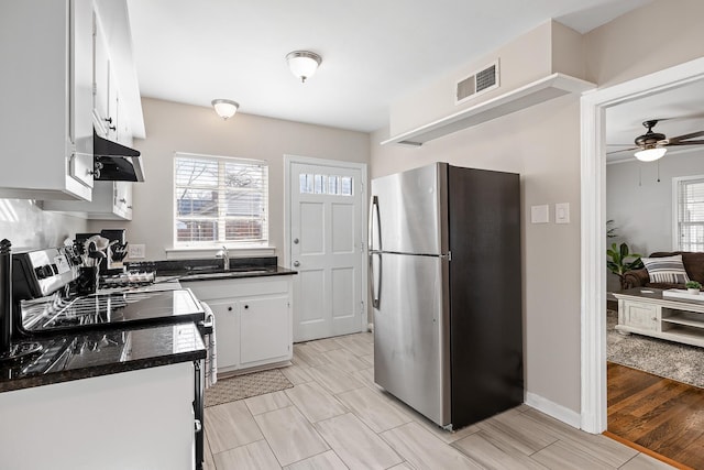 kitchen featuring white cabinets, light wood-type flooring, sink, and appliances with stainless steel finishes