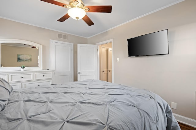 bedroom with hardwood / wood-style floors, ceiling fan, and crown molding