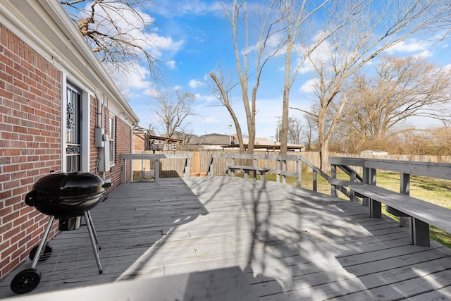 wooden terrace featuring a grill