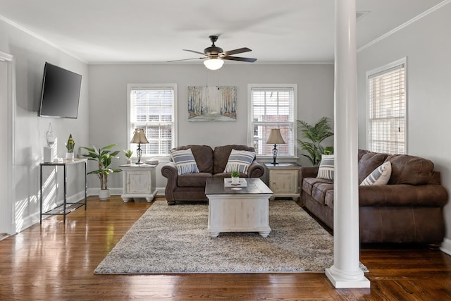 living room with dark hardwood / wood-style floors, a healthy amount of sunlight, ceiling fan, and decorative columns