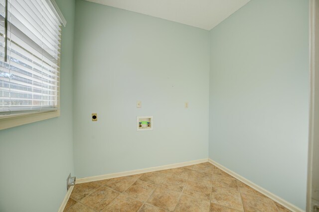 laundry area with hookup for an electric dryer, light tile patterned floors, and washer hookup