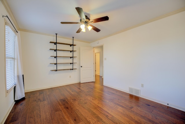 unfurnished room with ornamental molding, ceiling fan, and dark wood-type flooring