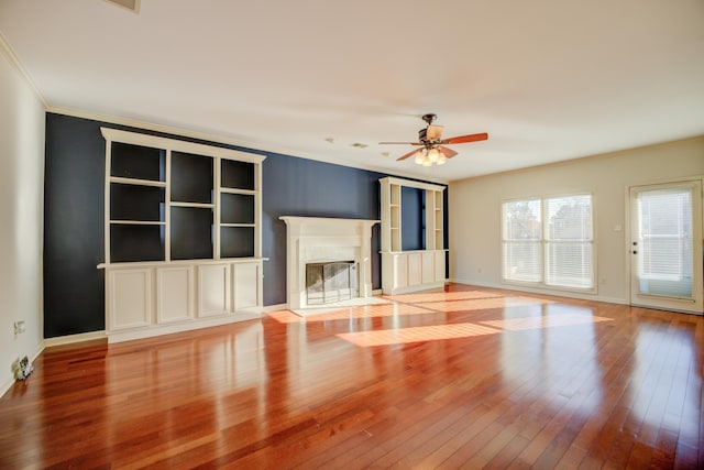 unfurnished living room with light hardwood / wood-style flooring, ceiling fan, and ornamental molding