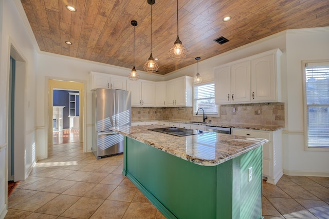 kitchen featuring a center island, stainless steel appliances, white cabinetry, and a wealth of natural light