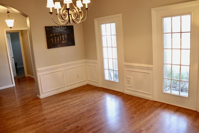 unfurnished dining area with dark hardwood / wood-style flooring and plenty of natural light