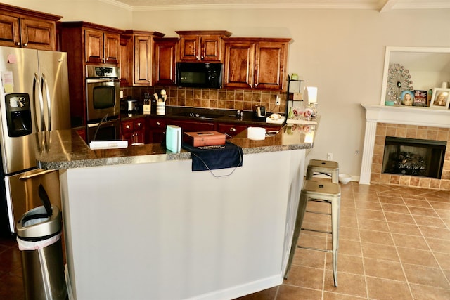 kitchen with a kitchen breakfast bar, light tile patterned floors, and black appliances