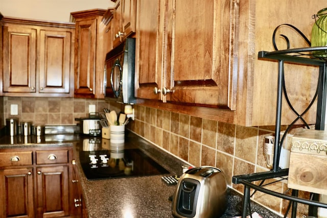 kitchen featuring tasteful backsplash and black appliances