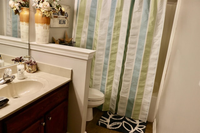 bathroom featuring tile patterned flooring, vanity, and toilet