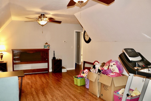 rec room with vaulted ceiling, ceiling fan, and dark hardwood / wood-style floors