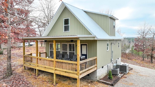 back of house with cooling unit and a wooden deck