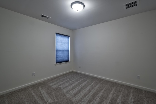 empty room with dark carpet