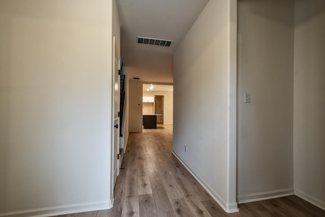 hall with light hardwood / wood-style floors