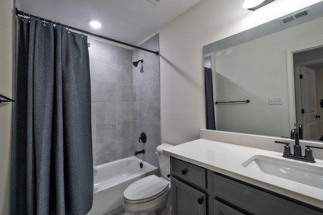 full bathroom with shower / bath combo with shower curtain, vanity, and toilet