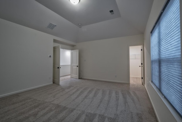 unfurnished room with carpet and lofted ceiling