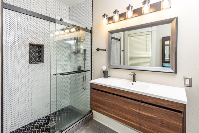 bathroom featuring tile patterned flooring, vanity, and walk in shower