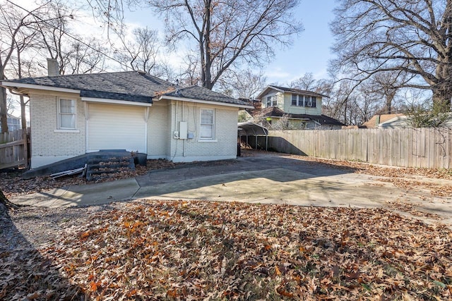 back of property featuring a carport