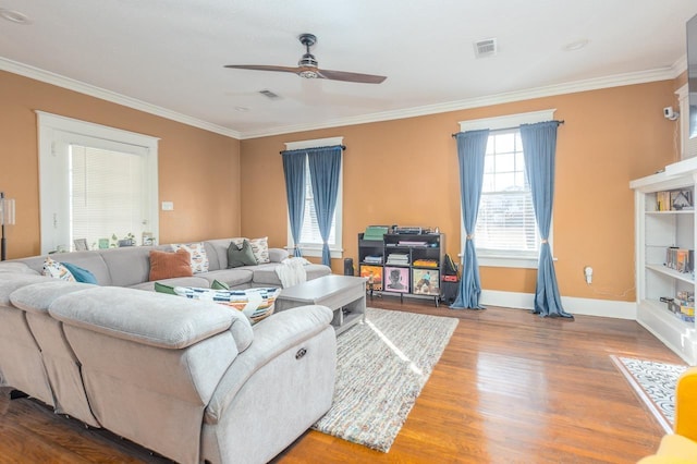 living room featuring ceiling fan, ornamental molding, and hardwood / wood-style flooring