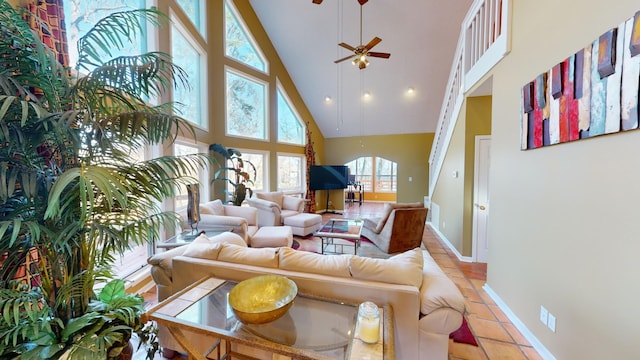 living room with light tile patterned floors, high vaulted ceiling, and ceiling fan