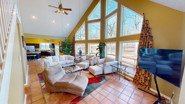 tiled living room featuring high vaulted ceiling, a wealth of natural light, and ceiling fan