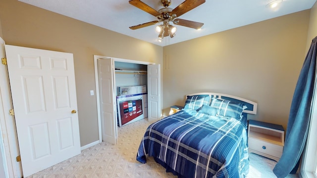 carpeted bedroom featuring ceiling fan and a closet