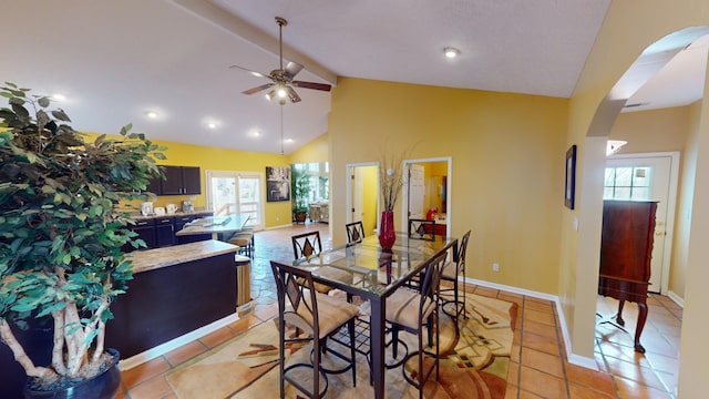 dining area featuring high vaulted ceiling, a healthy amount of sunlight, and light tile patterned floors