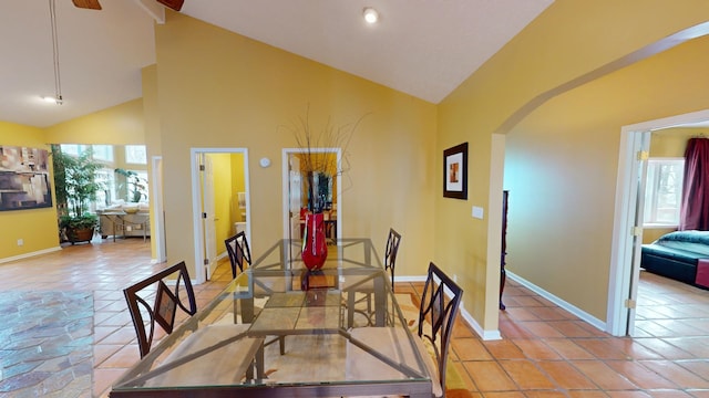 dining area with high vaulted ceiling