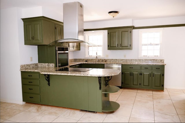 kitchen with kitchen peninsula, a breakfast bar, stainless steel appliances, island range hood, and sink