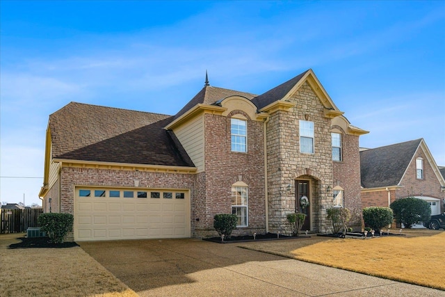 view of front facade with cooling unit and a garage