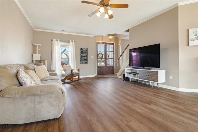 living room with hardwood / wood-style floors, ceiling fan, ornamental molding, and a textured ceiling