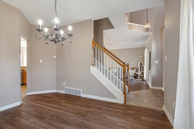 interior space with dark hardwood / wood-style flooring, a textured ceiling, and an inviting chandelier