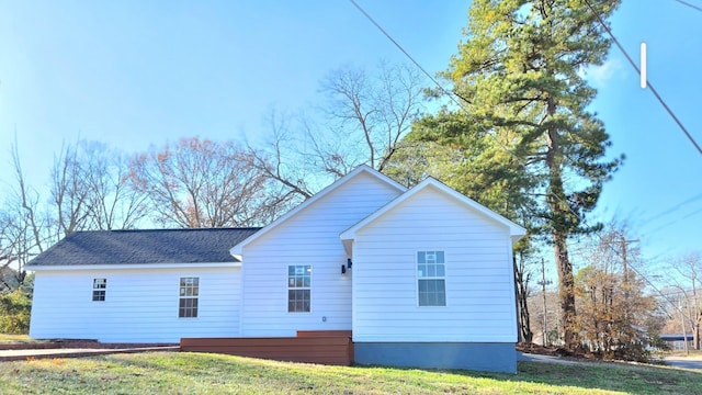 rear view of property featuring a yard