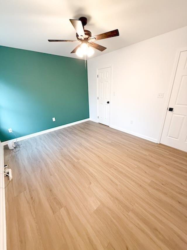 unfurnished room with ceiling fan and light hardwood / wood-style flooring