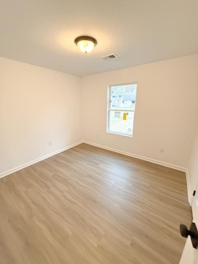 unfurnished room featuring wood-type flooring